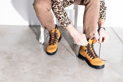 Samelin 5531 Sella waterproof nubuck leather hiking boots in yellow with lace-up design on a person.