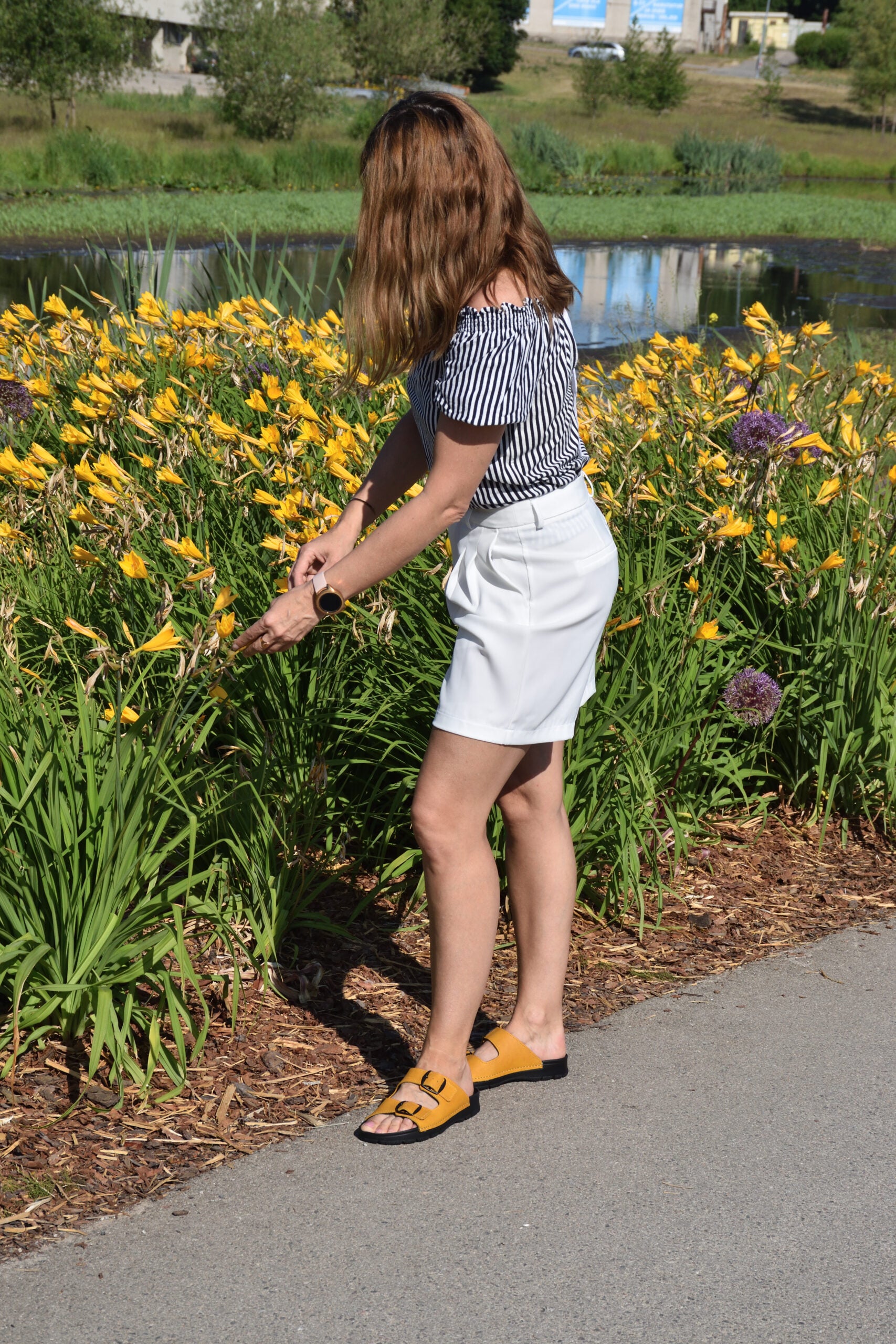Ocre Meeliku sandals by Omaking, featuring a minimalist design and comfortable fit, worn with a white skirt.