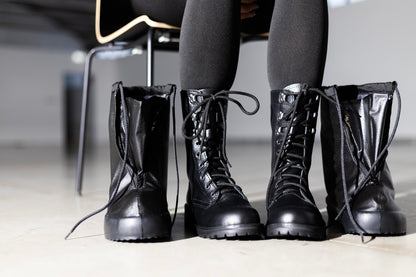 Black polyester waterproof overboots with PU sole, foldable design, and artificial fur lining by Samelin.