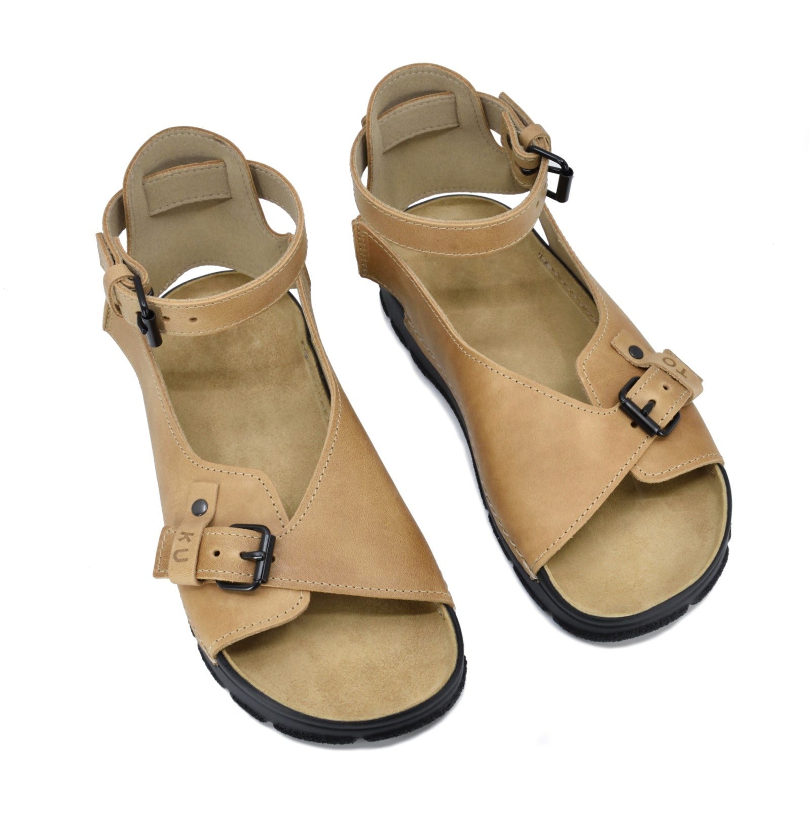Beige leather sandals with adjustable ankle straps and buckle detail by Omaking, available in sizes 36, 37, and 38.
