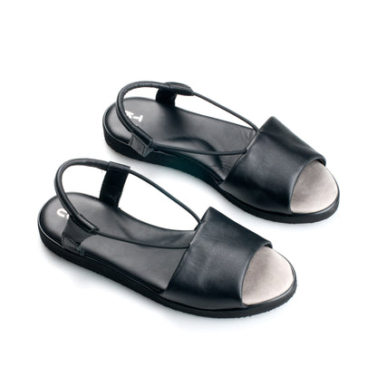 Black handmade leather sandals by TOKU with ergonomic design and casual open-toe style.