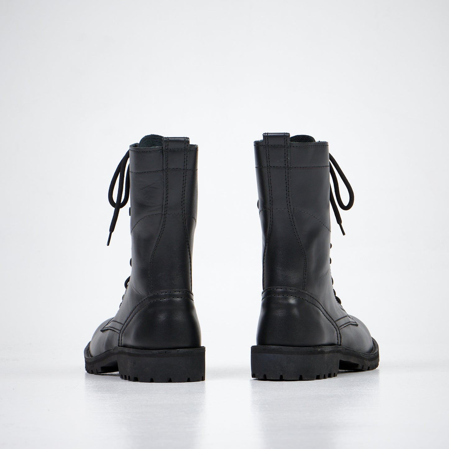 Black leather ankle boots with lace-up front and rugged sole, available in sizes 38, 40, and 52 by aipi.