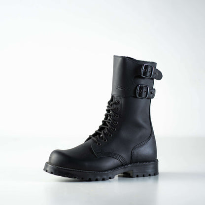 Black water-repellent leather military boots with lace-up front and buckled straps by Samelin