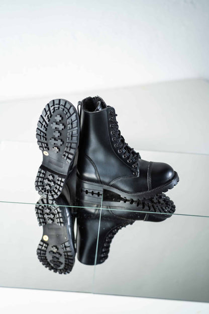 Black fur-lined genuine leather combat boots with lace-up front and rugged sole, by Samelin.